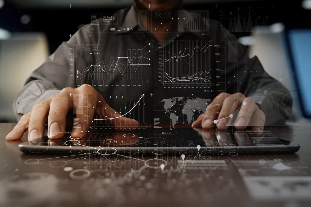 businessman hand working on laptop computer with digital layer business strategy and social media diagram on wooden desk-1